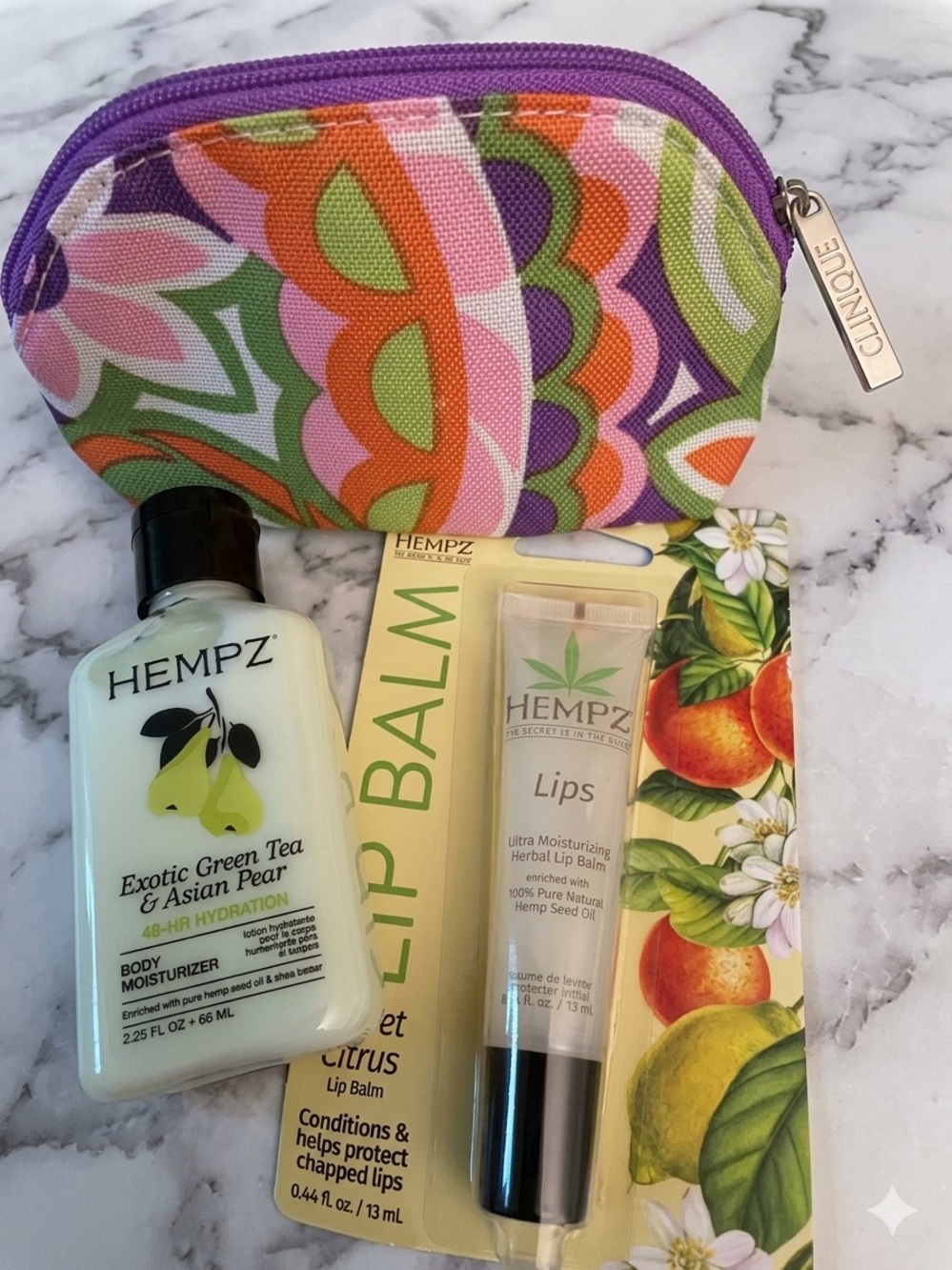 Hempz Green Tea & Asian Pear lotion and Hempz Citrus Lip Balm and Clinique pouch